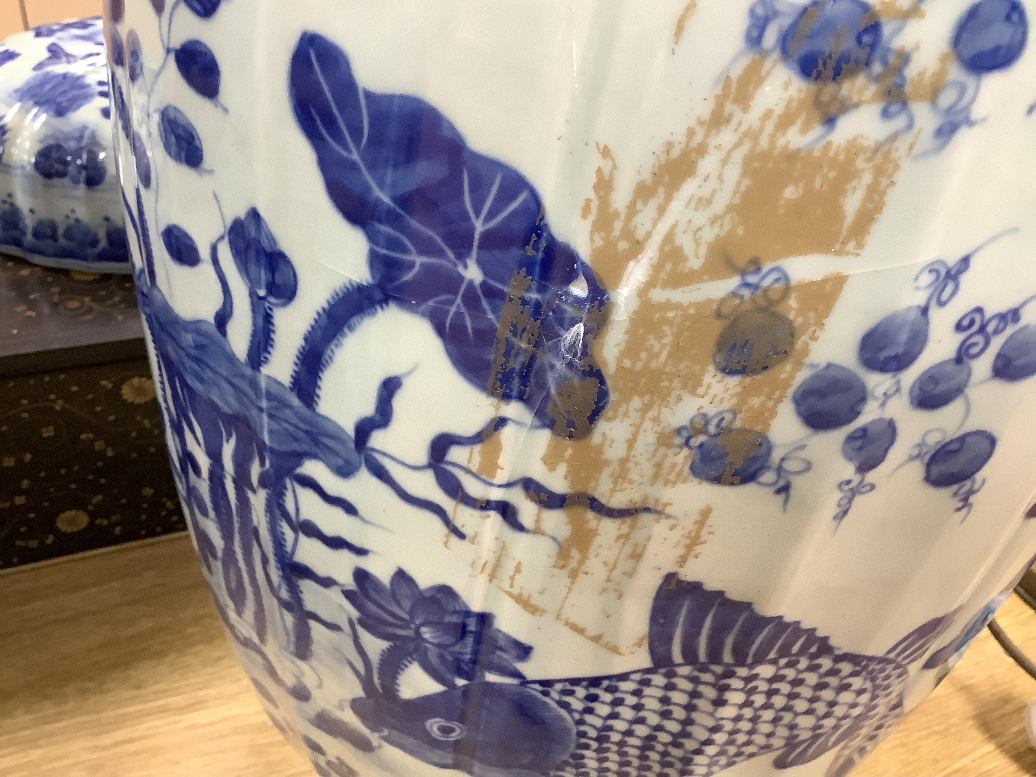 A large pair of Chinese blue and white ovoid jars and covers decorated with fish and lotus, 48cm high